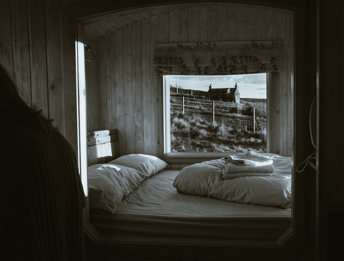 grayscale photo of bed with pillows