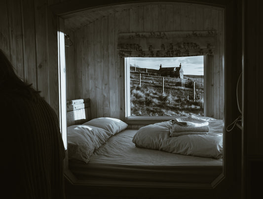 grayscale photo of bed with pillows