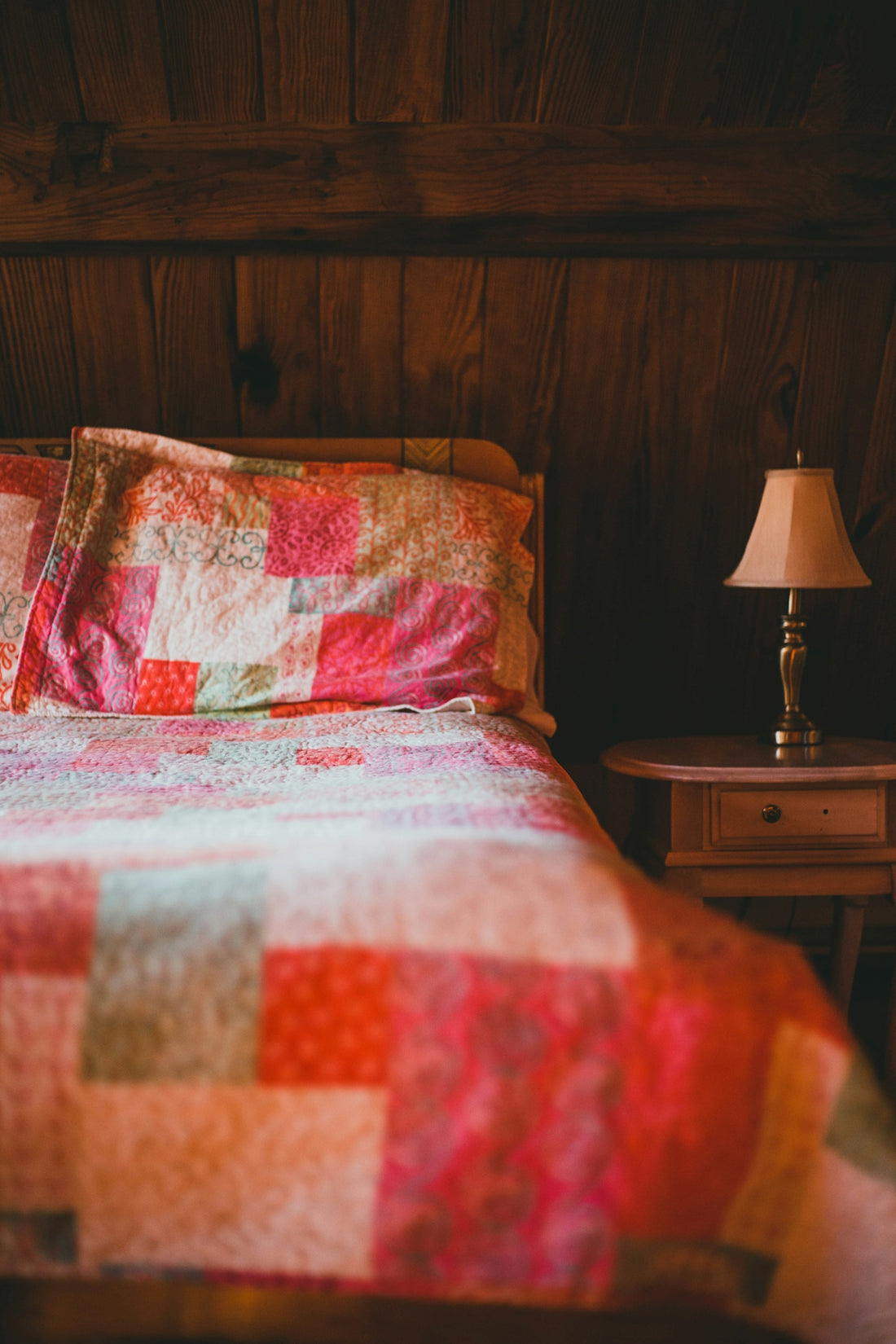 a bed with a colorful quilt on it