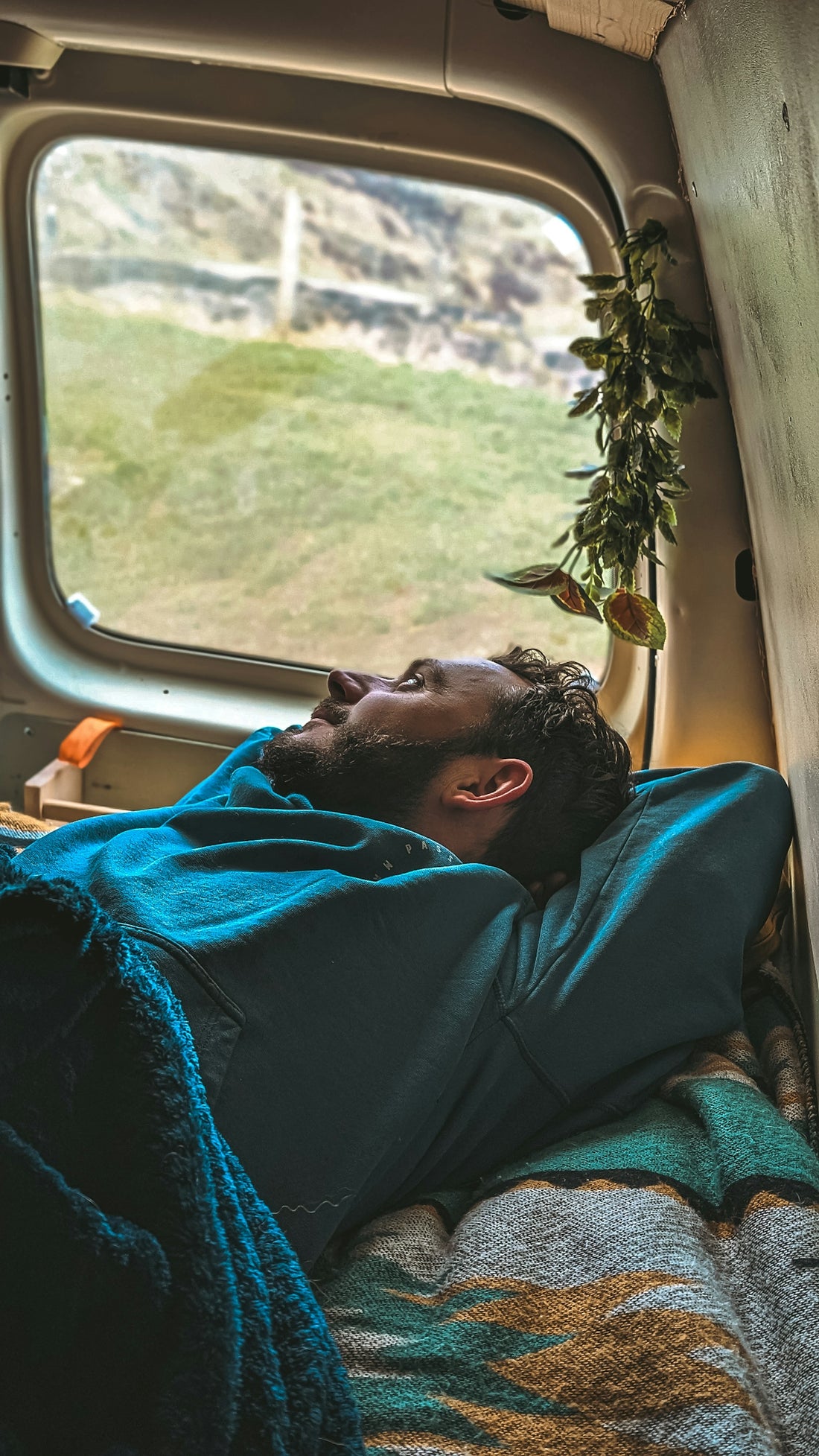 a man laying in a bed in a truck