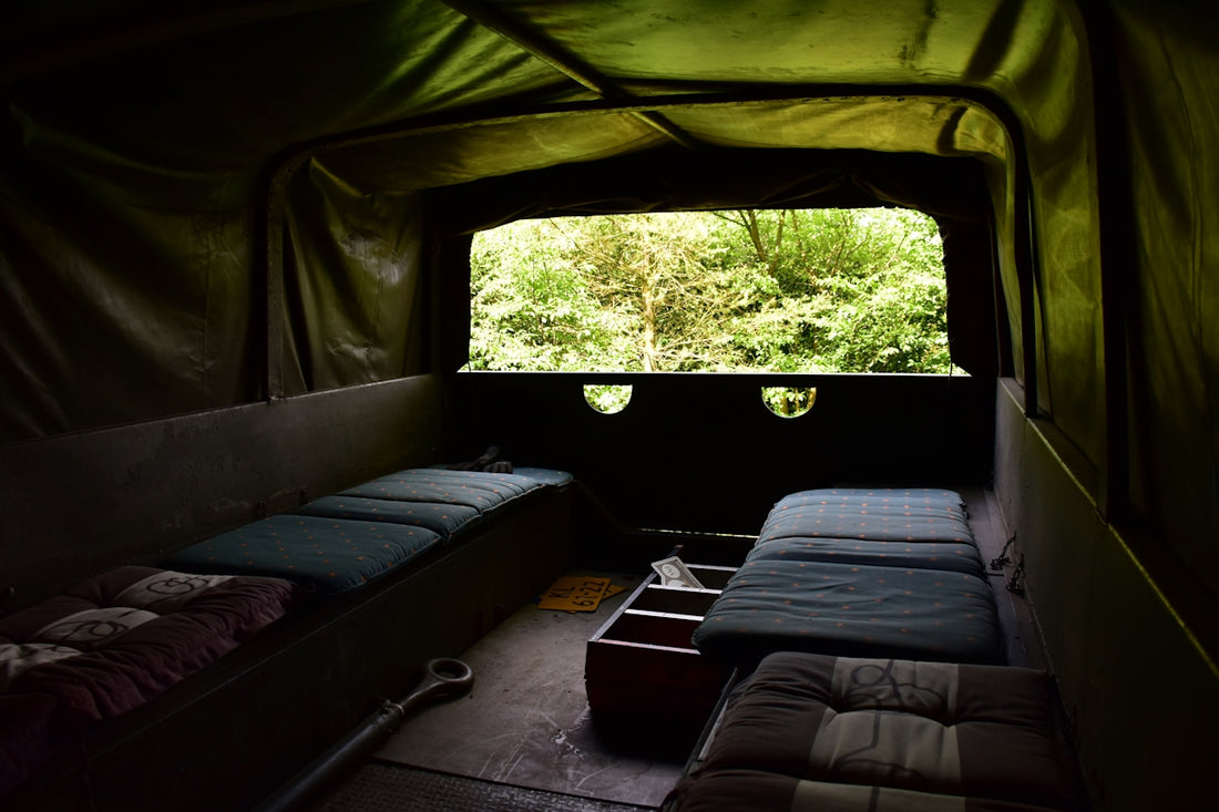 a couple of beds sitting inside of a tent
