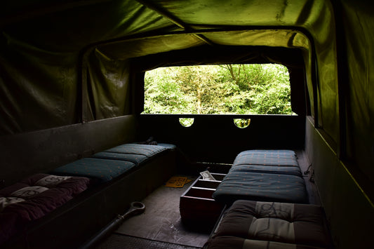 a couple of beds sitting inside of a tent