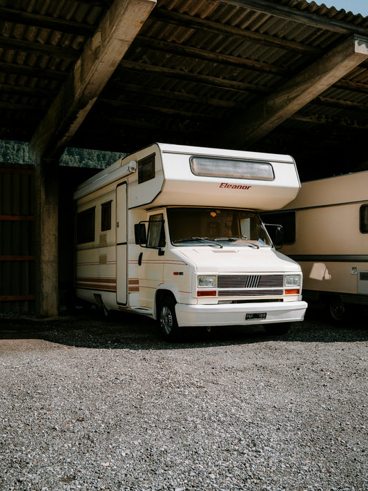 A couple of rvs parked in a garage