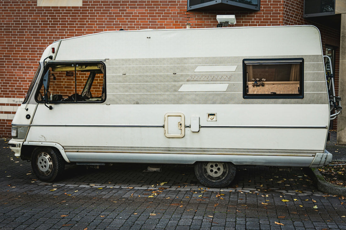 White vintage camper van parked outdoors