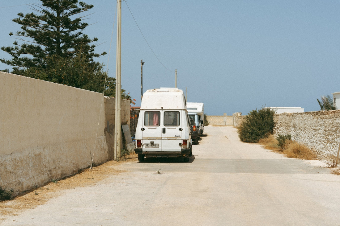 White camper van parked on dusty road
