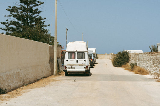 White camper van parked on dusty road