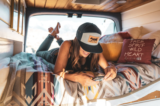 Young woman relaxing in a camper van.